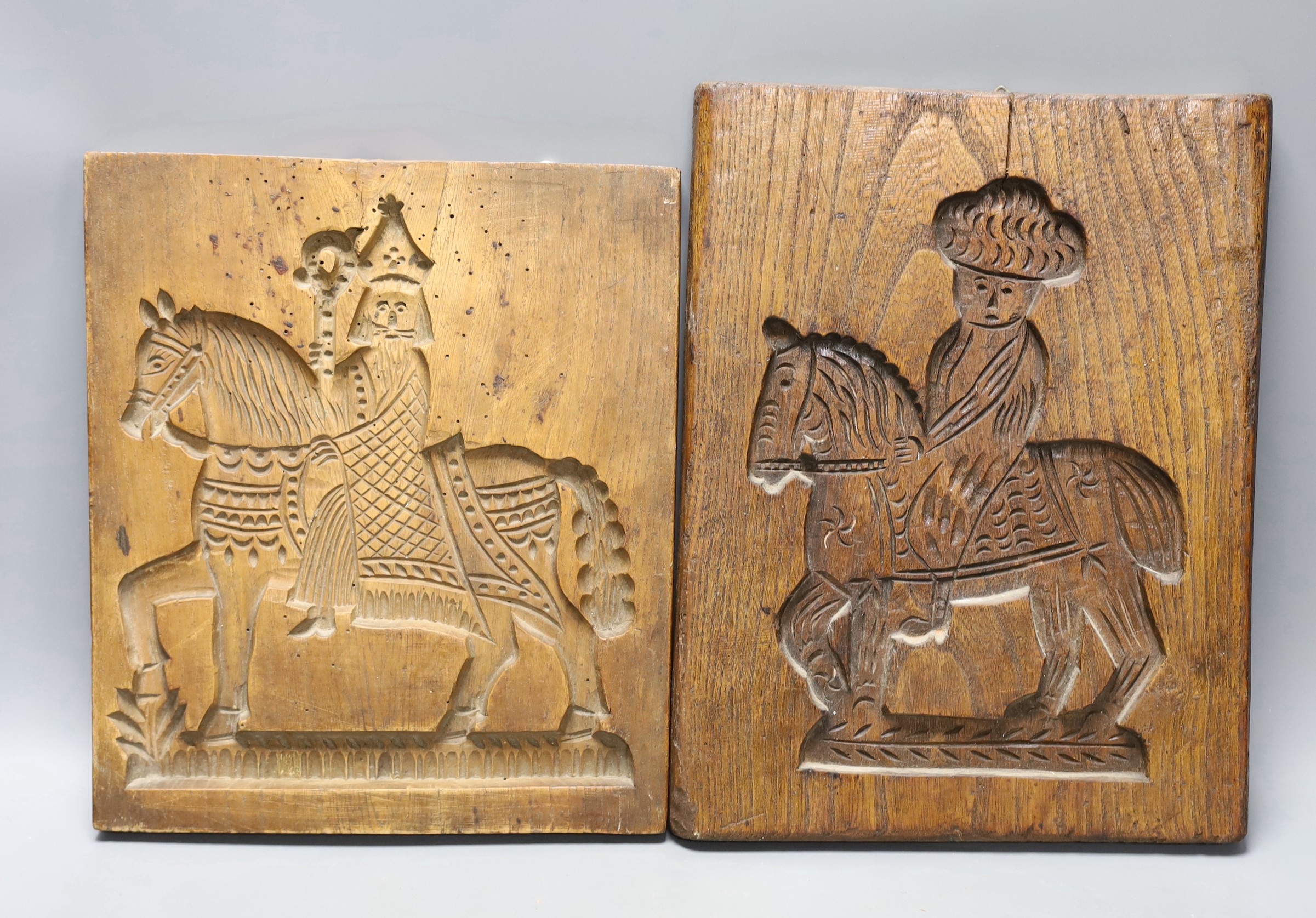 Two elm wooden wall carvings/moulds of men on horseback, one carved to reverse (2)